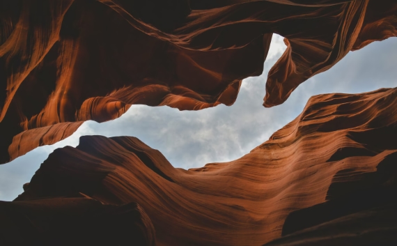 Layered sandstone canyon walls shaped by erosion, evoking layers of accumulated sediment like evolving APIs over time.”